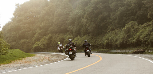 Obraz premium Three bikers riding big bike motorcycle touring on Inthanon National Park, Thailand.
