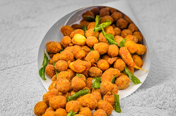 Traditional Indian snack - Masala Peanuts with Fried Curry Leaves in a Paper Cone