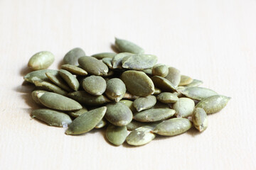 Pumpkin Seeds on Wood Background.