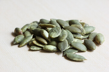 Pumpkin Seeds on Wood Background.