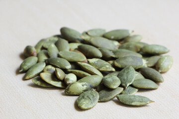 Pumpkin Seeds on Wood Background.