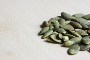 Pumpkin Seeds on Wood Background.