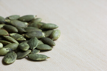 Pumpkin Seeds on Wood Background.