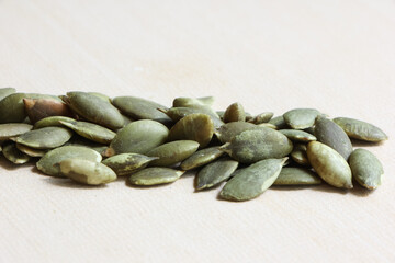 Pumpkin Seeds on Wood Background.