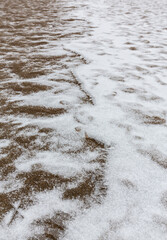 Abstract shapes with sand dunes covered by fresh powder snow, in a wild river bed, in winter