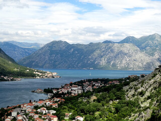 Fototapeta premium Aerial view of Kotor bay and old city in Kotor, Montenegro. Kotor is a coastal town in a secluded Gulf of Kotor, its preserved medieval old town is an UNESCO World Heritage Site. 