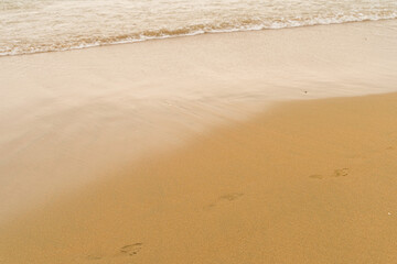 Fototapeta na wymiar footprints on the sand