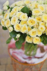 Beautiful flower bouquet of yellow rose. Big bouquet of roses in vase on table.