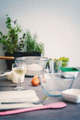 Various ingredients for making dessert on the table. Notebook with a recipe and a glass of wine. Hobby lifestyle concept