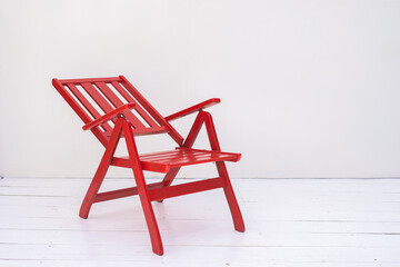 Red wooden chair on a white background.