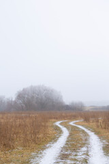 Beautiful country road covered with fresh snow and frost, in winter, in remote rural location