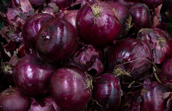 Fresh purple onion as background. Purple onion on the market