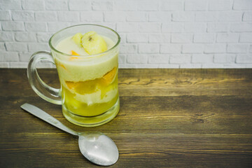 glass of Kolak on wooden table