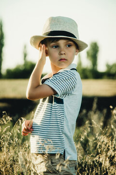 boy with hat in a wheat field close-up
