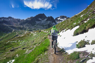 Fototapeta na wymiar Mountain biking in a small narrow mountain path