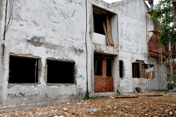 A house looking run down and dilapidated with heavy renovation, restoration and rebuilding works in...