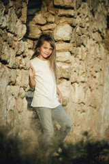 teenage girl resting by an abandoned building