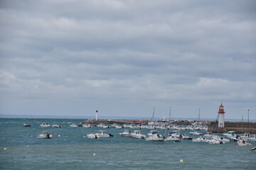 Fototapeta premium Harbour in the Bretagne with boats and the sea visible. 