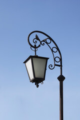 Fototapeta na wymiar Vintage street lamp on blue sky