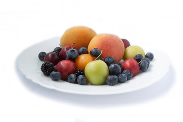 Mix of Fruits Apricots Blueberries blackberries plums on a plate