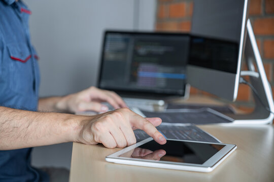 Young Professional programmer working at developing programming and website working in a software develop company office, writing codes and typing data code, Programming with HTML, PHP and javascript