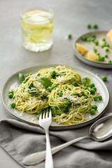 spaghetti with pesto sauce, parmesan and green peas