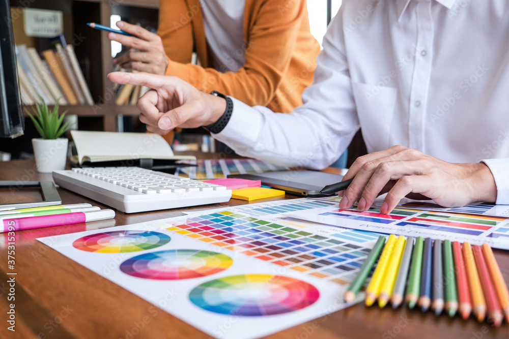 Poster two colleague creative graphic designer working on color selection and color swatches, drawing on gr