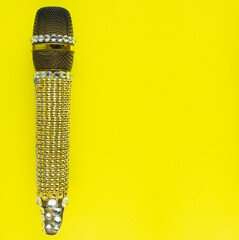 Professional vocal radio microphone decorated with bright shiny and glittering gold rhinestones on...