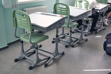 Moderd school smart classroom without young student.View of elementary class room no kid or teacher with chairs and deskd tables in campus. Primary school bags.