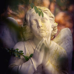 Figure of a praying angel. An very ancient stone statue.