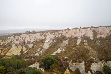 Fototapeta na wymiar Natural landscape of Cappadocia, semi-arid region in central Turkey known for its distinctive fairy chimneys, tall cone-shaped rock formations clustered in Monks Valley, Göreme and elsewhere- Kayseri