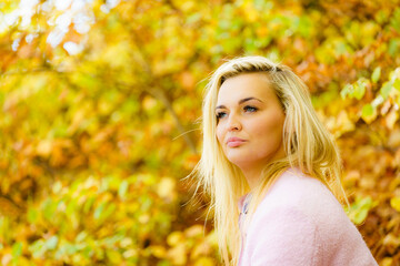 Blonde woman relaxing in autumn park