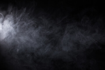 Cloud of white smoke on a black background closeup