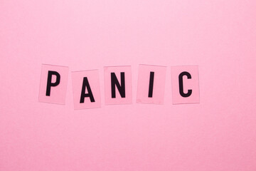 The inscription panic on a pink background close-up.