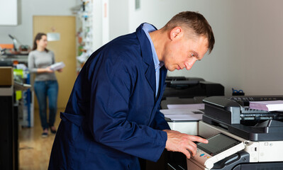 Service engineer using a copy machine. High quality photo
