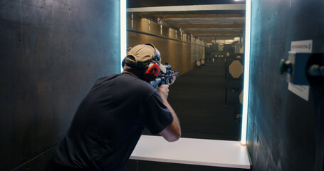 Professional shooter firing at target