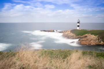 Fototapeta na wymiar lighthouse in isla pancha,asturias (spain)