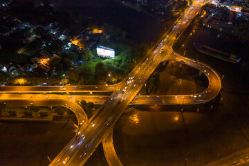 Fototapeta na wymiar symmetrical Aerial view of freeway interchange offramp and bridge over canal with traffic