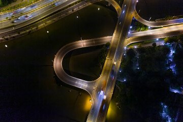 Aerial view of freeway interchange offramp and bridge over canal with traffic from medium height