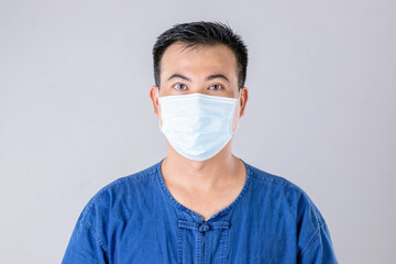 Thai farmer wearing protective face mask to prevent virus studio shot on grey background