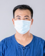 Thai farmer wearing protective face mask to prevent virus studio shot on grey background