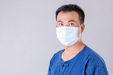 Thai farmer wearing protective face mask to prevent virus studio shot on grey background