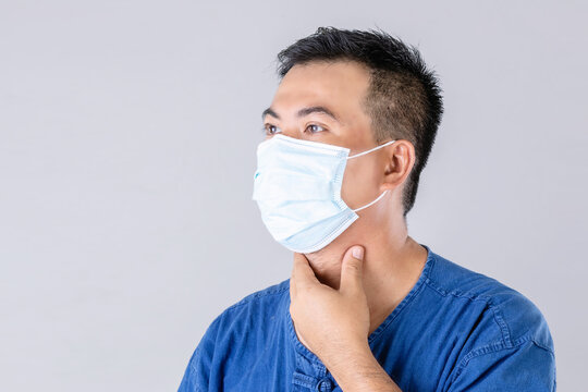 Thai Farmer Wearing Protective Face Mask To Prevent Virus And Touch On Neck Studio Shot On Grey Background