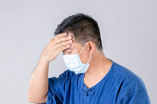 Thai Farmer Wearing Protective Face Mask To Prevent Virus And Touch On Head Studio Shot On Grey Background