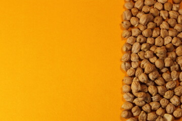 Egyptian chick peas on the right side of an orange background