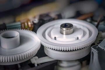 Plastic cogs and gears inside printer.