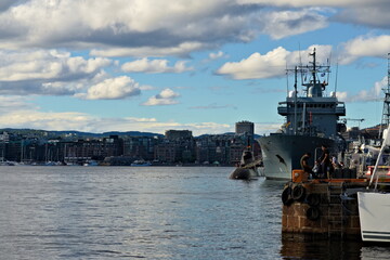 Oslo, Norway - Aug. 29th 2020: Anglers fishing in the harbor alongside German warships.