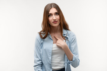 Obraz premium Photo of of indignant brunette female points at herself with for finger