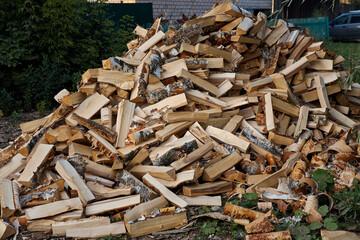 a pile of firewood lying on green grass