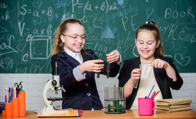 Little girls scientist work with microscope. Little girls in school lab. Science is future. Biology science. Happy little girls. Chemistry research. science experiments. Confident student studying